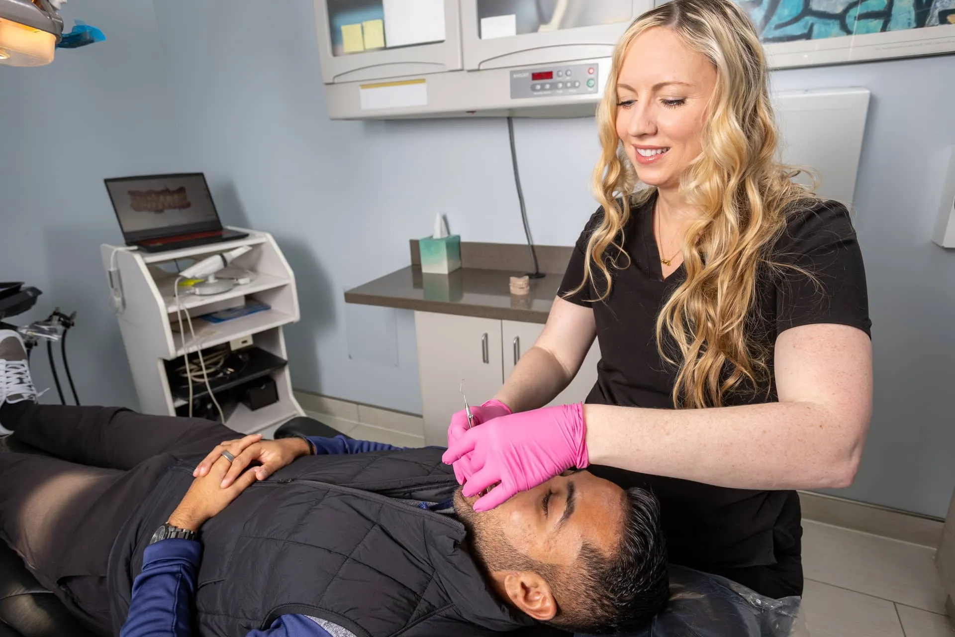 Big City Dental team member caring for a patient in the treatment chair