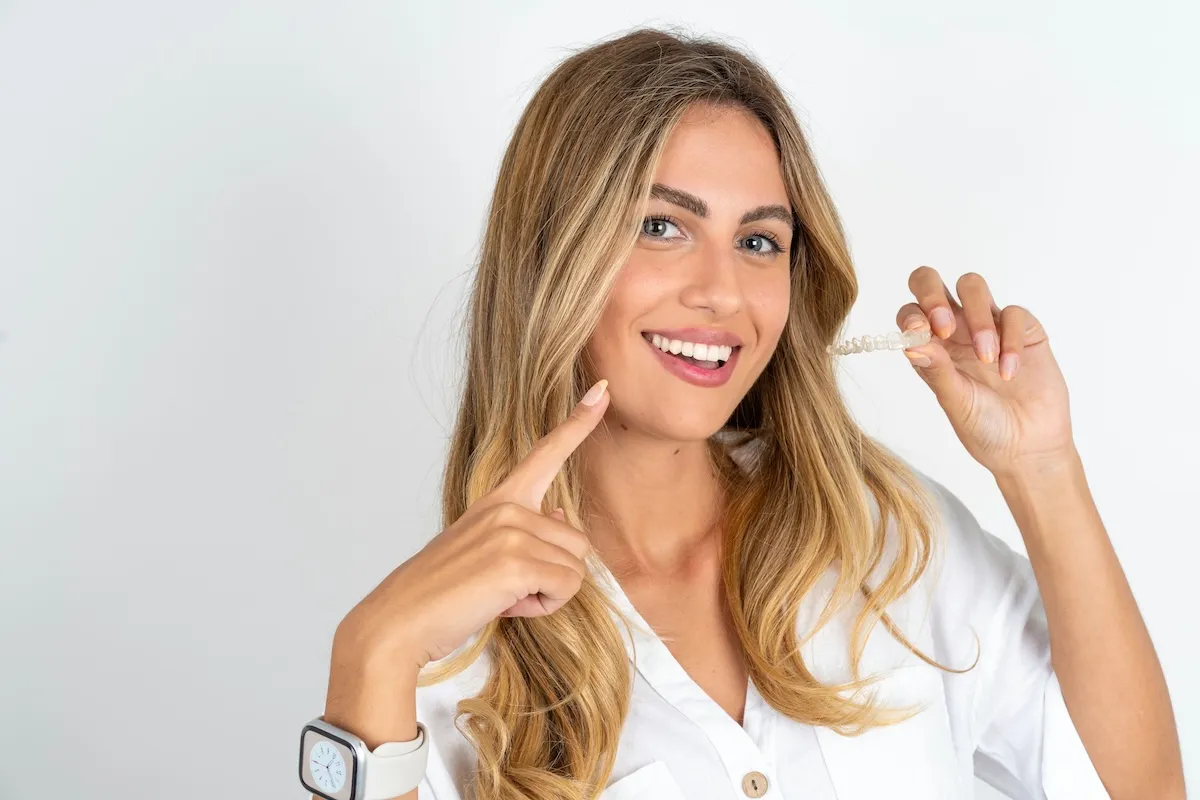 Woman holding a clear aligner tray